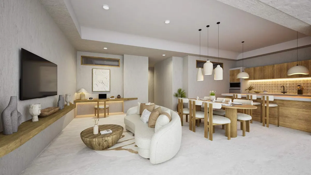 A render of an Atrium Lombok apartment: a curved white sofa and a round timber table, a dining table under pendant lights, and a timber kitchen behind.