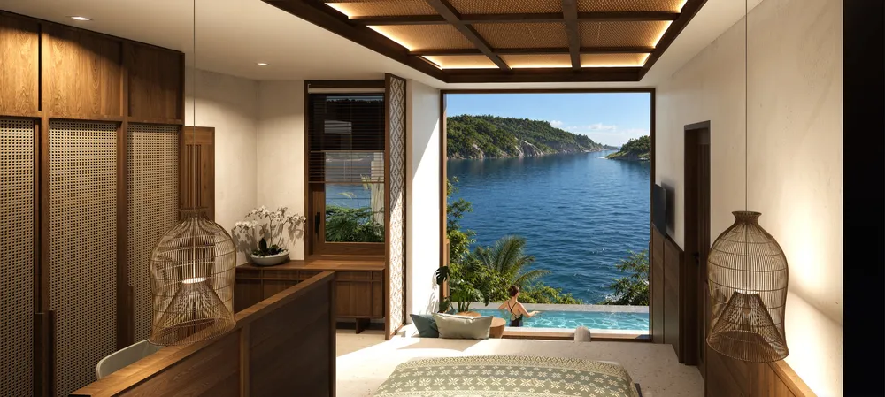 A render of a one-bedroom villa's bedroom, with timber walls and rattan lamps, and an open wall onto the plunge pool and the bay.